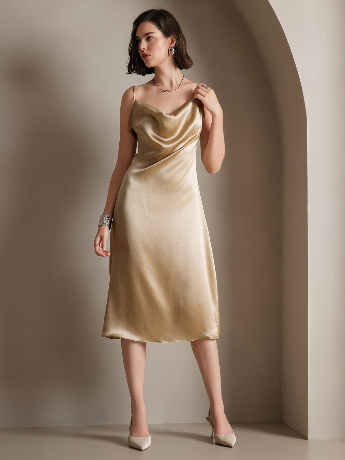 Woman in a champagne satin slip dress